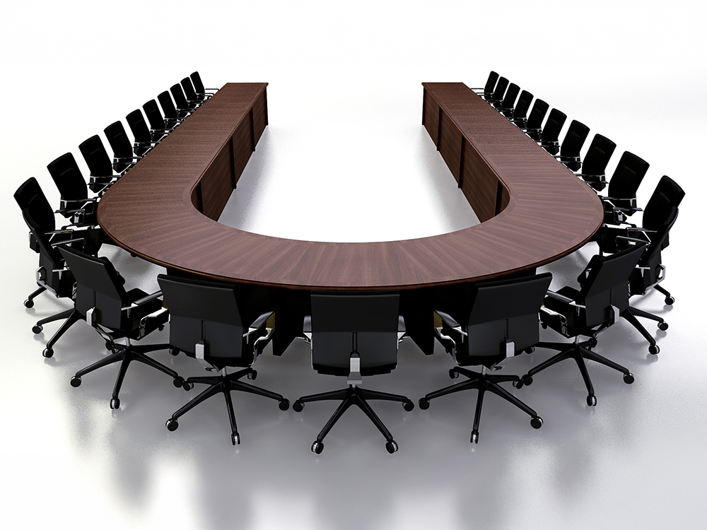 Large custom U-shaped conference room table with deep, dark wood veneer for videoconferencing including AV integration
