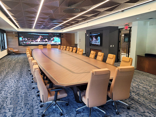 Intricate wood pattern boat conference table with sophisticated AV integration