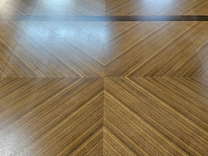 Intricate wood pattern boat conference table with sophisticated AV integration