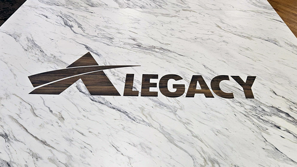 Precision logo inlay detail in composite laminate conference table surface