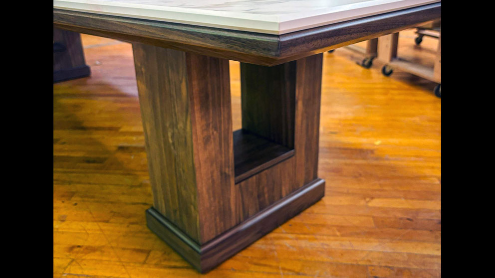 Solid wood pedestal base supporting custom conference table